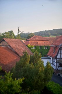 Rural countryside houses mingling with nature, ivy growing on walls, view of traditional Fachwerk