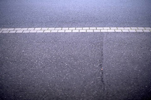 Weather conditions caused a crack in the street asphalt requiring public maintainance financed by