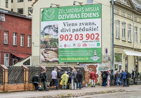 People queue at a soup kitchen, Krisjana Barona iela, Riga, Latvia