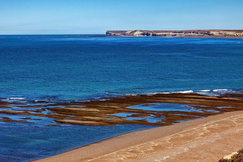 Rocky, cliff-rich coast with deep blue water and clear views, the landscape of Peninsula Valdes in