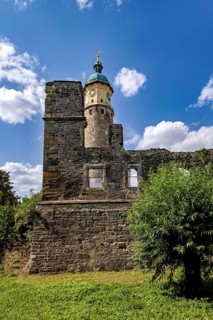 Tower and ruins against a clear blue sky with scattered clouds, The Niedeck Ruins in Arnstadt