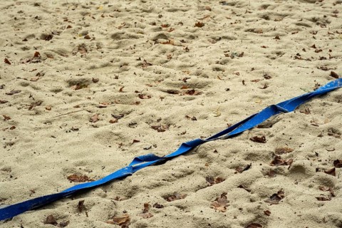 Borken-Hoxfeld, NRW, Germany, A stretch of sandy beach shows blue tape running across, marking a
