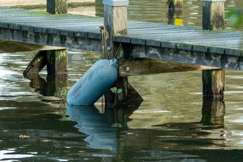 Borken, nrw, germany, buoy attached to old wooden dock over water, Borken, nrw, germany
