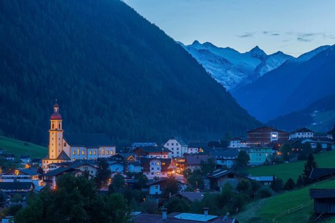 View of town with mountains and Stubai glacier at dusk, Neustift im Stubai Valley, Stubai Valley,