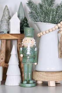 Beautiful farmhouse or boho style Christmas home decoration with trendy mint green nutcracker