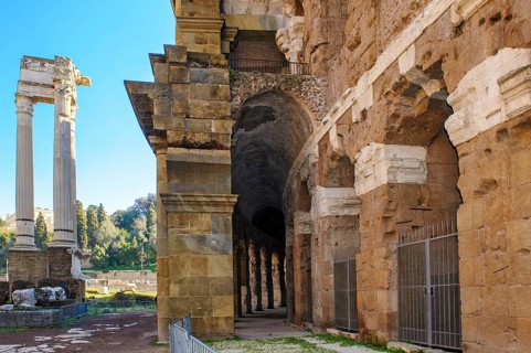 Center and right part of preserved façade of historic ancient Marcellus Theatre, left ruin of