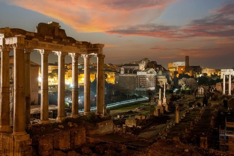 Night view photo at dusk evening view of Roman Forum, left column ruin remains of Temple of Saturn,