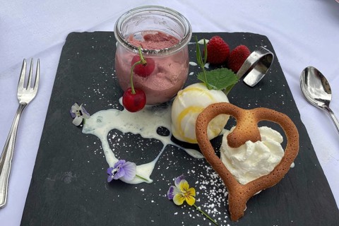 Dessert sweet dish cherry mousse with vanilla ice cream and heart-shaped pastry, international
