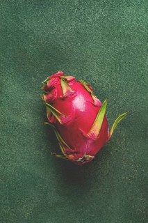 Dragon fruit, pitahaya, one piece, top view, rustic style, green background
