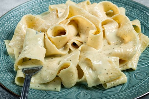 Pasta papardelle in creamy garlic sauce, traditional Italian cuisine, pasta carbonara, homemade, no