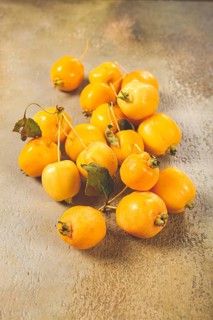 Yellow small apples, Chinese variety, scattered on the table, top view, no people