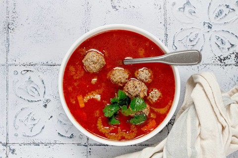 Romanian soup with meatballs, vegetable soup with meatballs, tiled table, homemade, no people
