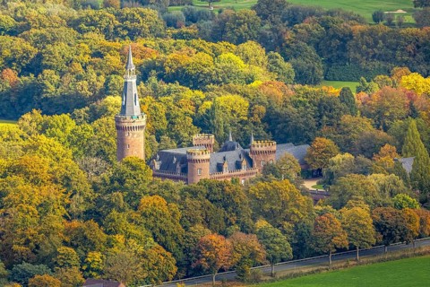 Aerial view, Moyland Castle Museum, neo-Gothic moated castle and castle park surrounded by meadows