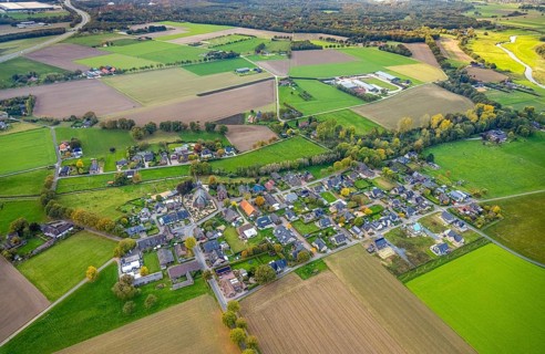 Aerial view, residential area town view district of Hommersum with parish church of St. Peter and