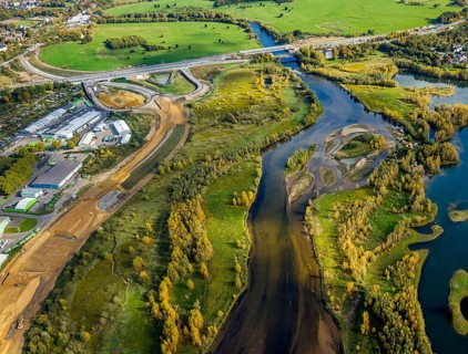 Aerial view, lip embankment, construction site and new building extension and feeder federal road