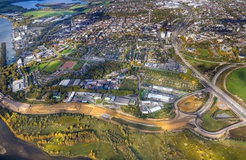 Aerial view, lip mouth area, construction site and new building extension and feeder federal road