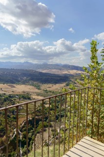 Ronda, malaga, spain Viewpoint balcony overlooking the vast valley with mountains and fields under