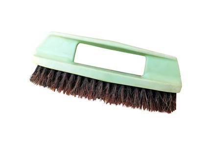 Old green plastic shoe brush on a isolate white background