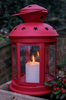Red lantern with burning candle surrounded by a festive atmosphere, North Rhine-Westphalia, Germany