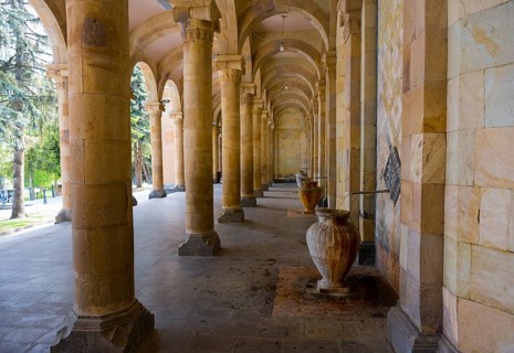 Spacious portico with jugs and symmetrical stone arches that combine historical flair with natural