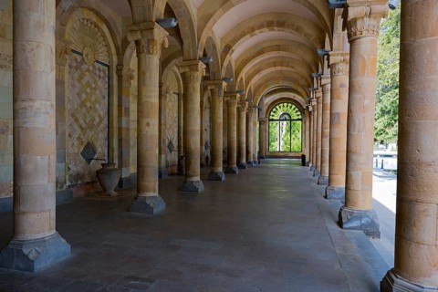Historic colonnade with symmetrical stone arches in a cool interior, Mineral Water Gallery in