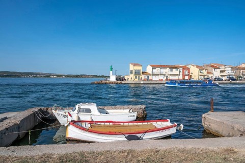 Two moored fishing boats in the foreground with a view across the Canal de Sete, formerly Canal