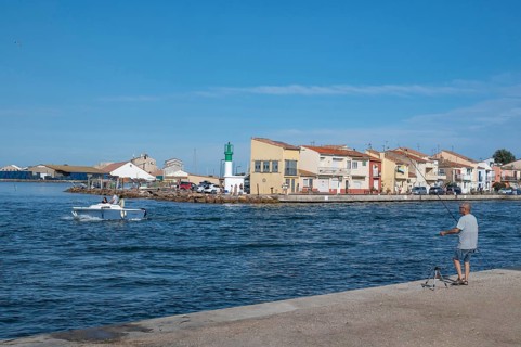 An angler looks from the banks of the Canal de Sete, formerly Canal Royal, across to the