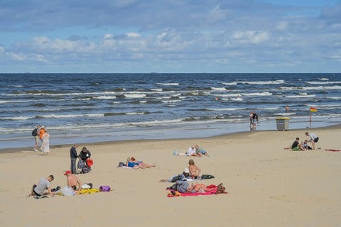 People on sandy beach, Baltic Sea, waves, Jurmala, Latvia