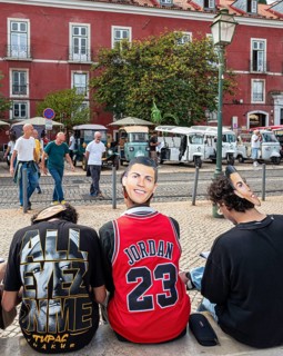 Street art, young people with Ronaldo mask on the back of their heads taking part in a school
