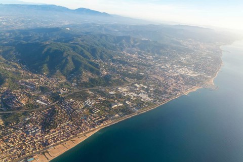 Oblique aerial view of settlements on coastal plain and hillsides, Mediterranean Sea coast, El