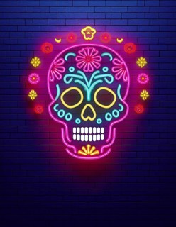 A vibrant neon sugar skull design is illuminated against a dark brick wall, symbolizing the