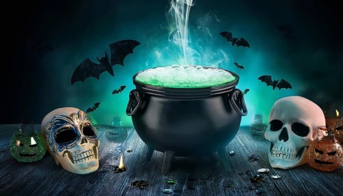 A bubbling cauldron emits green smoke, surrounded by skulls and bats in a spooky Halloween setup.