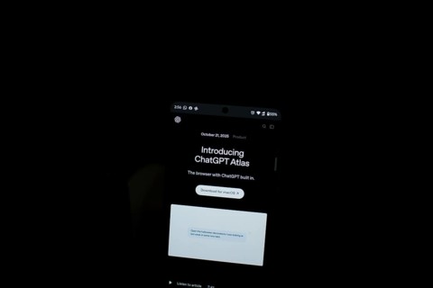 Smartphone displaying ChatGPT Atlas text in a dark setting
