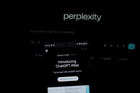 Smartphone screen with ChatGPT Atlas text against a background labeled perplexity