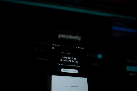 Dimly lit smartphone screen showing ChatGPT Atlas details