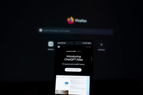 ChatGPT Atlas displayed on a smartphone with a Firefox screen in the background