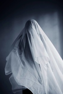 Woman with a white cloth width, ghost costume