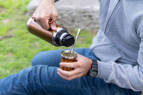 The process of cebar mate: young person preparing the south american infusion