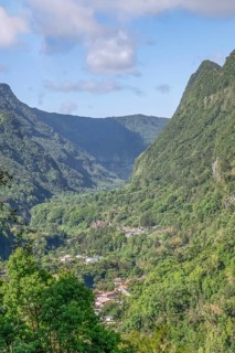 View from Department 52 of the massive, steep Remparts rock faces of Cirque du Salazie and a hamlet