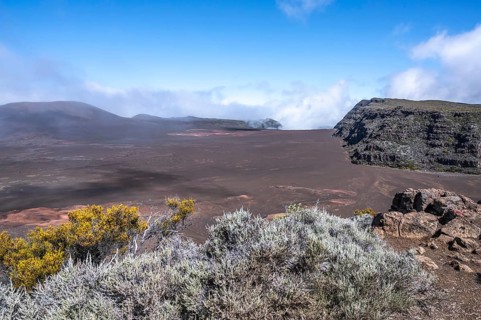 View from Pas de Bellecombe on the Route du Volcan of the Enclos Fouque caldera with rust-red