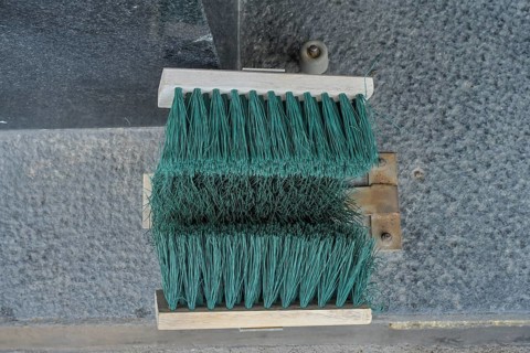 Broom at the entrance to the house, device for cleaning shoes in winter, Helsinki, Finland