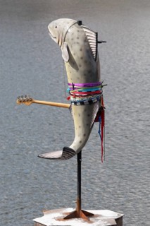 Fish sculpture with guitar, art installation What If They Bark by conceptual artist Cosima von