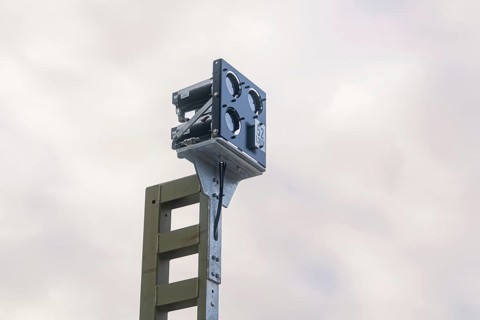 Close-up of a camera or sensor construction against a cloudy sky, signal building at the Hermann