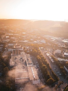Urban industrial area in morning fog illuminated by warm sunlight, Calw Stammheim, Black Forest,