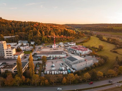 Industrial plant surrounded by autumn trees and fields in the evening, Aidlingen, Böblingen