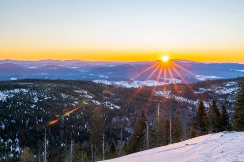 Sunrise over the hills of czech republic from Mount Lusen wth the view over the hills of the