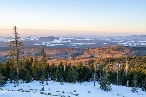 View from Mount Lusen over the hills of the bavarian forest at sunrise in winter, Bavaria, Germany