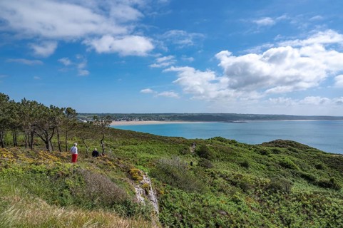 An elevated panorama shows the vast landscape of Cap d'Erquy covered with pine, broom and low
