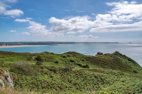 The elevated panorama shows the pine, broom and low scrub landscape of Cap d'Erquy and the