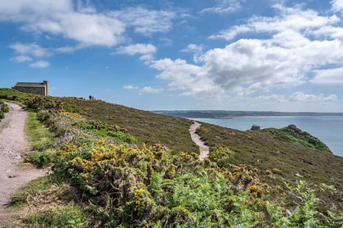 An unpaved coastal path, the Sentier Littoral GR 34 long-distance hiking trail, snakes across the